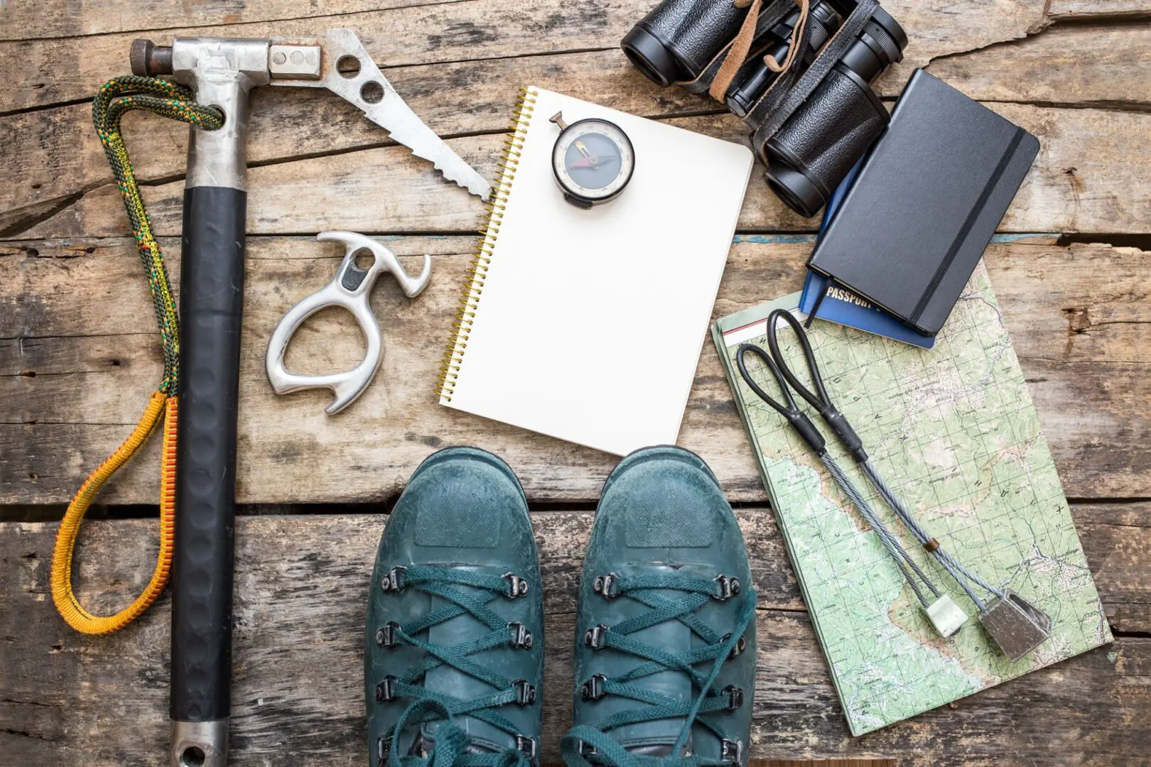 Hiking gear and boots on wooden surface.