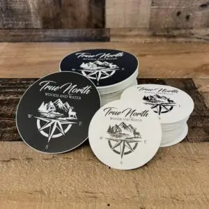 Round coasters with compass and rose designs in black and white.