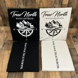 Two fabric rolls with compass and text designs in black and white.