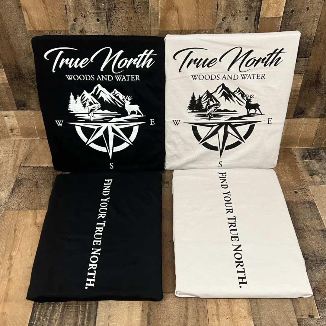 Two fabric rolls with compass and text designs in black and white.
