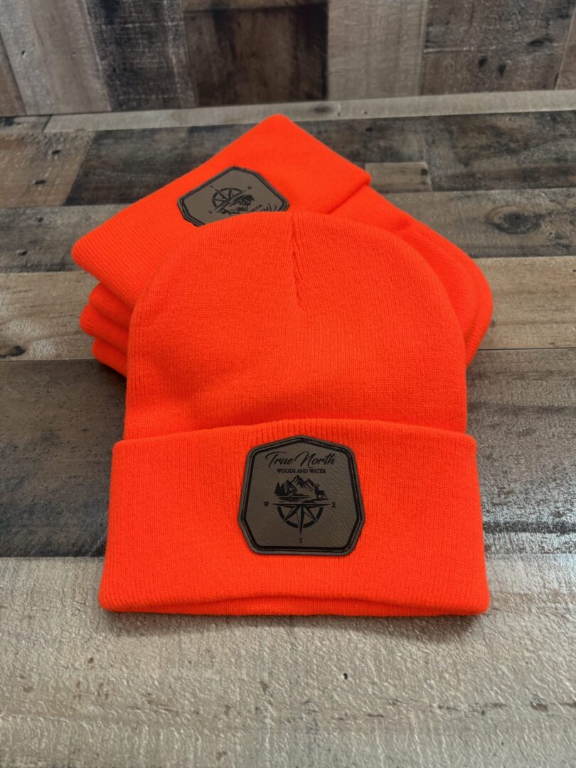 Bright orange beanies with a Marine Corps emblem patch.