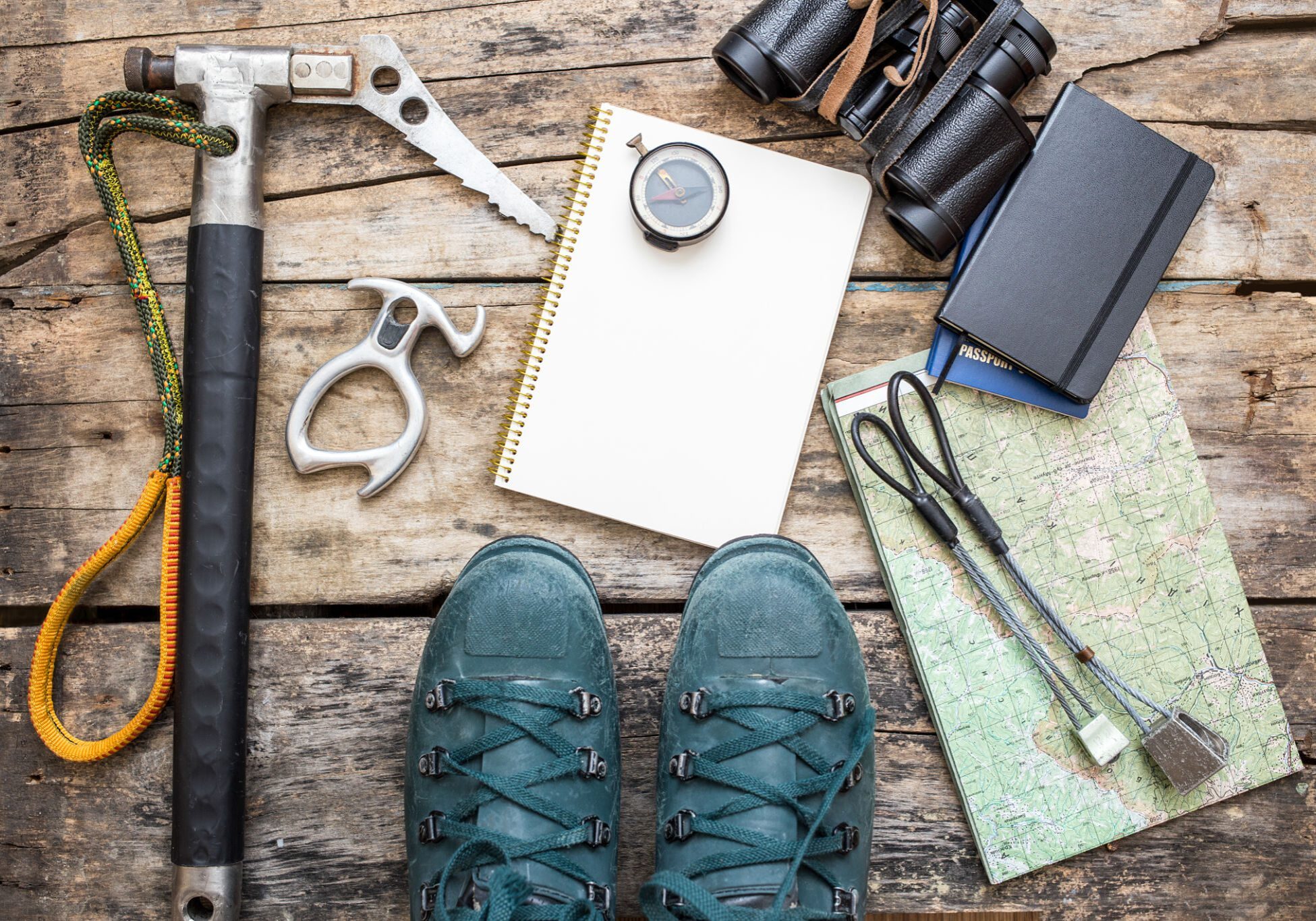 Hiking gear and boots on wooden surface.